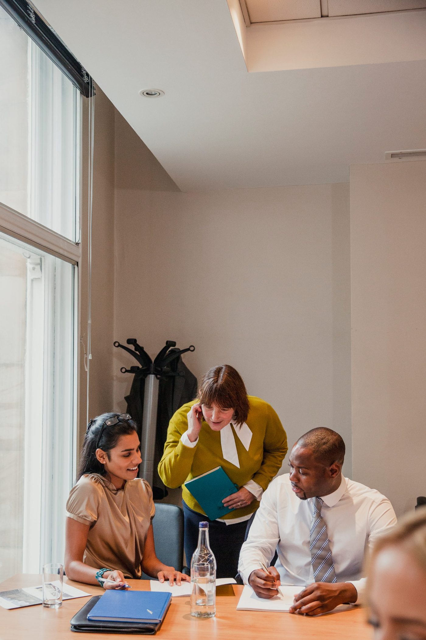 Colleagues in discussion around a boardroom table