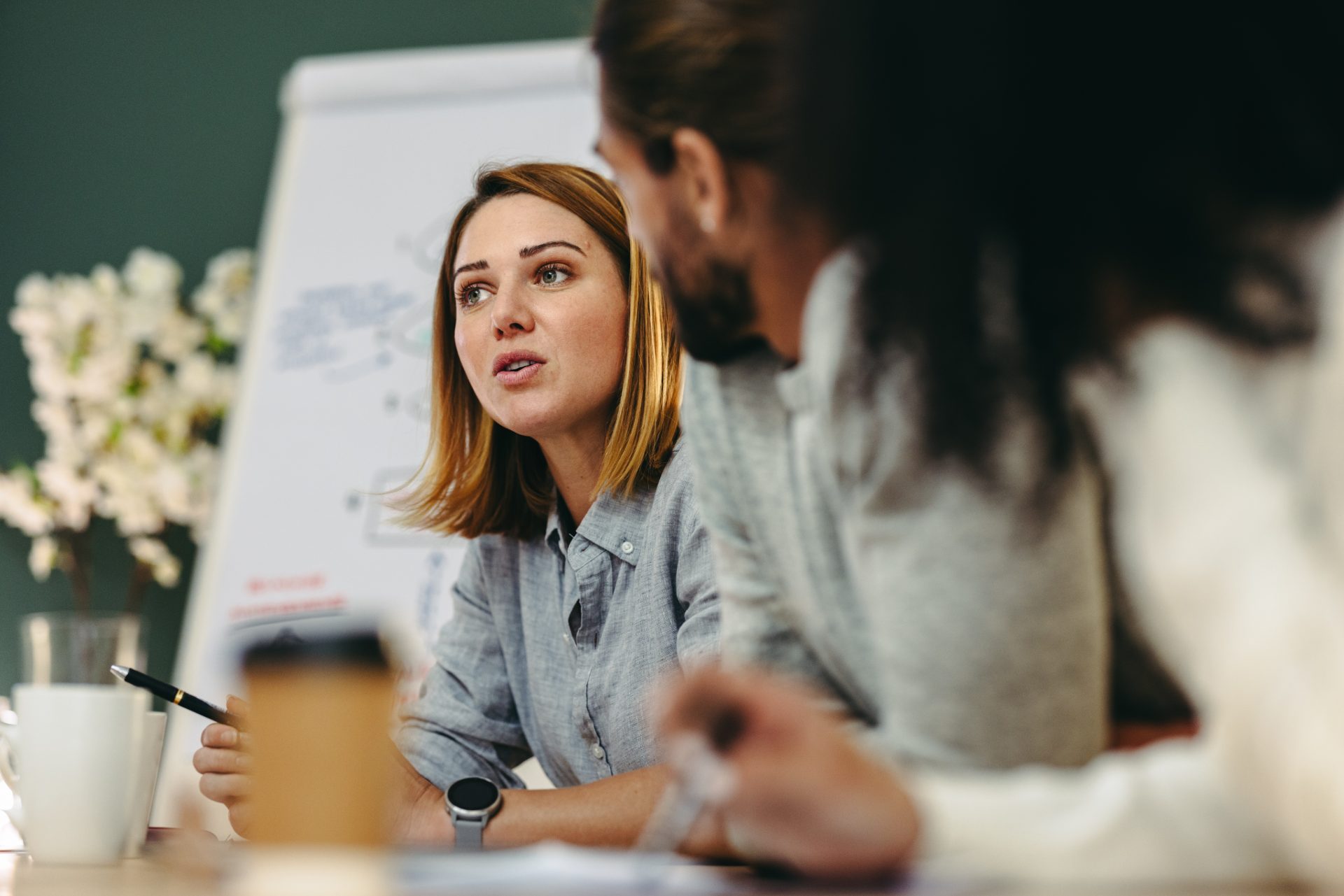Two colleagues in discussion beside a flip chart