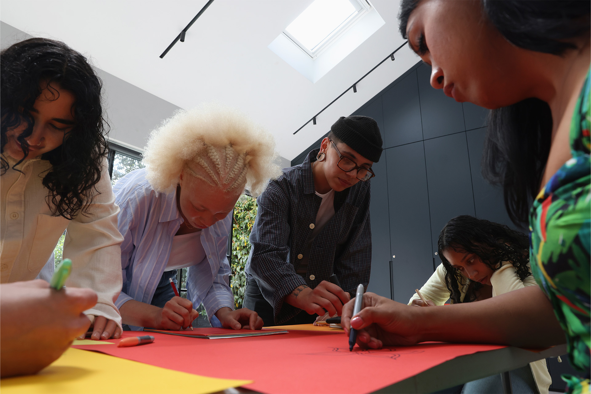 A facilitator at a flipchart of clustered sticky notes, turning back to the group