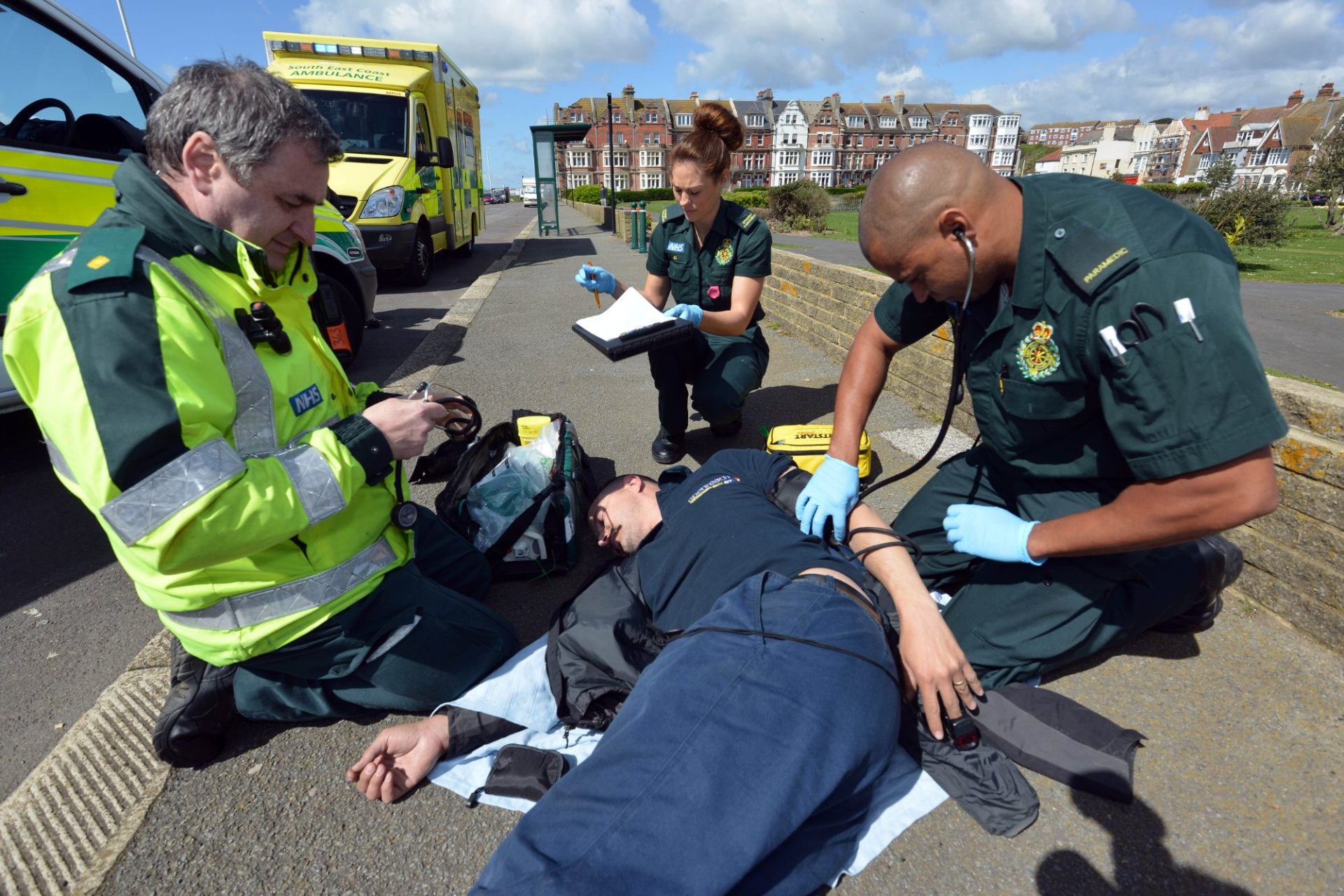 An ambulance crew treating a patient at a roadside incident