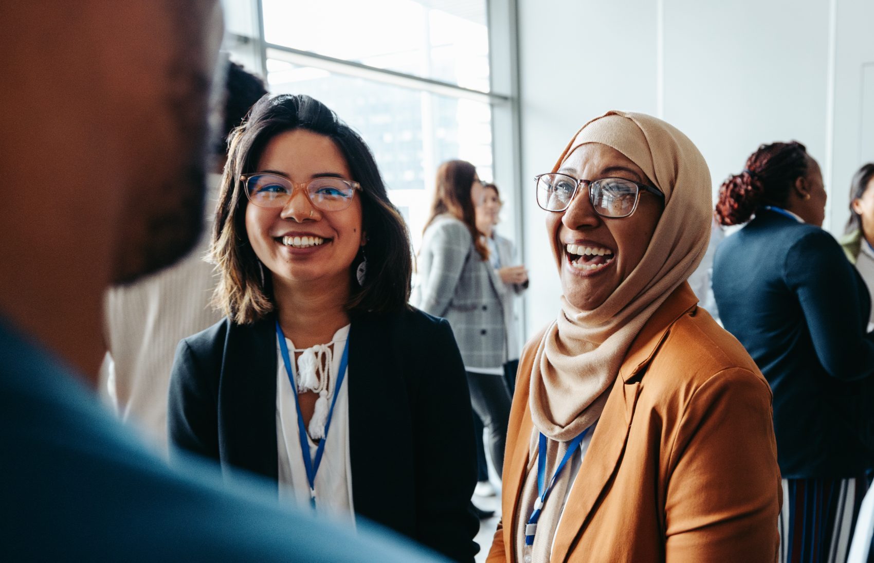 Members talking and laughing together at a tCI networking event