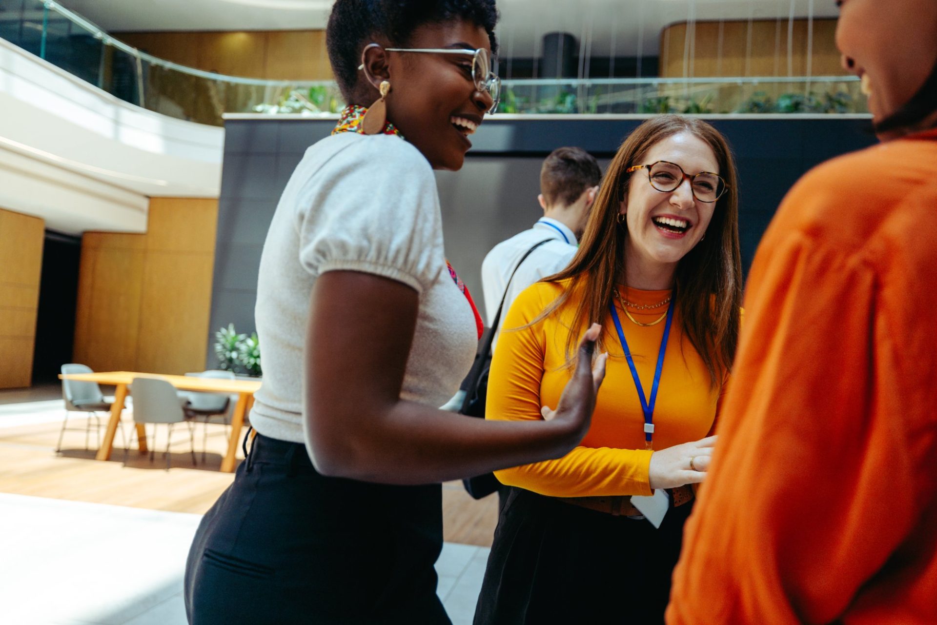 Colleagues laughing together at a networking event
